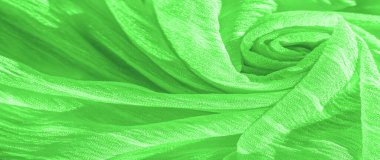 İpek kumaş. Yeşil kırışık kumaş dokusu. Yeşil buruşuk, dalgalı yüzey dokusu. Yakın çekim, yumuşak odaklanma. arkaplan, kalıp
