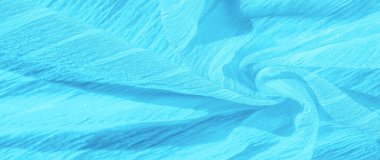 İpek kumaş. Mavi buruşuk kumaş dokusu. Mavi buruşuk, dalgalı yüzey dokusu. Yakın çekim, yumuşak odaklanma. arkaplan, kalıp