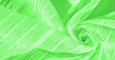 İpek kumaş. Yeşil kırışık kumaş dokusu. Yeşil buruşuk, dalgalı yüzey dokusu. Yakın çekim, yumuşak odaklanma. arkaplan, kalıp