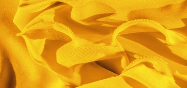 Sarı ipek. Pürüzsüz, zarif, sarı, lüks ipek kumaş kopya alanı olan soyut bir arkaplan olarak kullanılabilir. Renkli doku