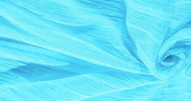 İpek kumaş. Mavi buruşuk kumaş dokusu. Mavi buruşuk, dalgalı yüzey dokusu. Yakın çekim, yumuşak odaklanma. arkaplan, kalıp