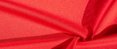 Kırmızı ipek. Soyut bir arka plan olarak, lüks kırmızı ipeğin veya satenin dokusunu kullanabilirsiniz. Renkli doku, arkaplan, desen