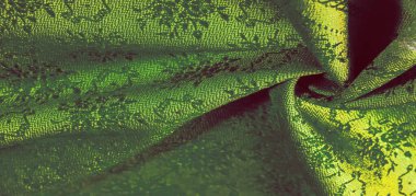 yeşil ipek kumaş. Pürüzsüz yeşil ipek ya da saten lüks kumaş dokusu soyut bir arkaplan olarak kullanılabilir. Lüks arka plan tasarımı. Doku, desen