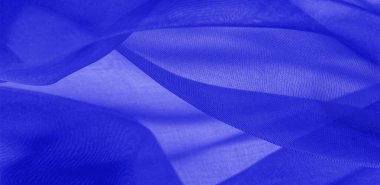 Mavi ipek kumaş dokusu. Pürüzsüz, zarif mavi ipekten ya da saten kumaştan. Lüks kumaş. soyut bir arkaplan olarak kullanılabilir.