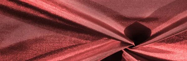 ruby red silk fabric, metallic shades of fabric, shiny red metallic background for decorative design, decor element, wallpaper. texture pattern