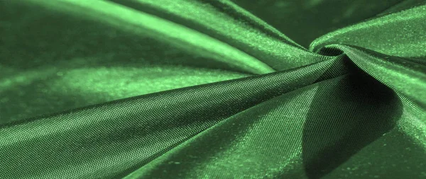 emerald green silk fabric, metallic fabric shades, shiny green metallic background for decorative design, decor element, wallpaper. texture pattern