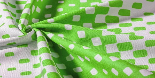 Silk fabric with a pattern of green squares on a white background. texture background pattern.