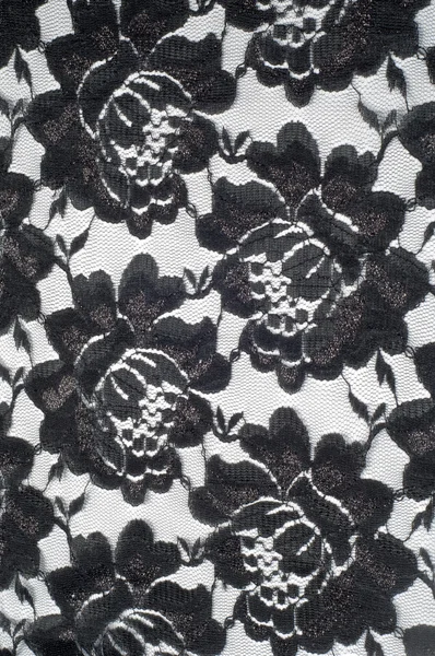 Кружево на черно-белой ткани — стоковое фото