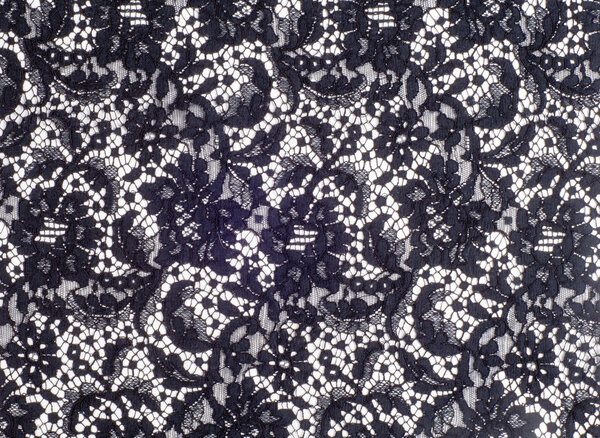Texture lace fabric. lace on white background studio. thin fabric made of yarn or thread. typically one of cotton or silk, made by looping, twisting, or knitting thread in patterns
