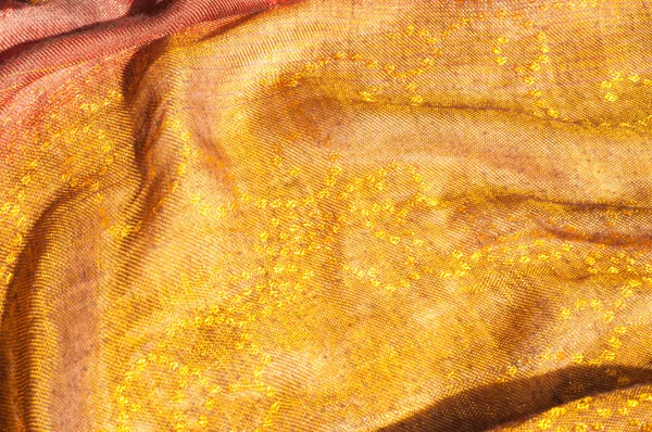 A textura do tecido de lã amarelo vermelho dourado — Fotografia de Stock