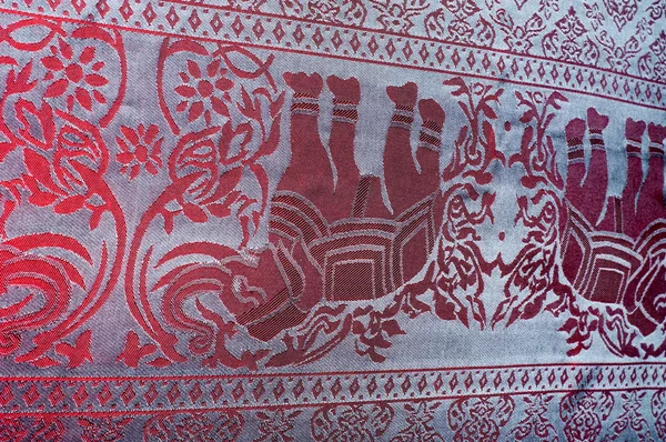 The texture of cotton fabric, with red painted elephants, made in India