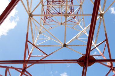 Doku enerji ayağı. Elektrik pilon mavi gökyüzü karşı detay: yüksek gerilim elektrik direği aşağıdan