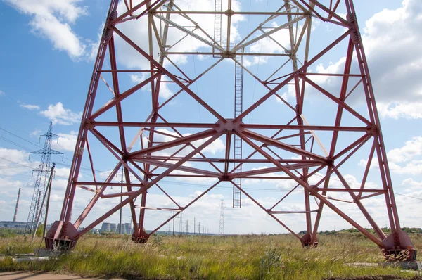 Texture energy pillars. Detail of electricity pylon against blue sky: high voltage electric pillar from below