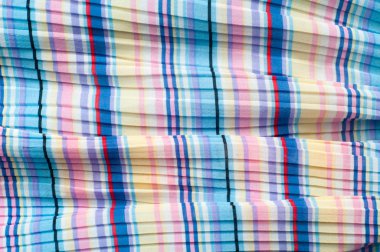 Pileli kumaş. Sinii sarı kırmızı beyaz çizgili doku. Fotoğraf stüdyosu