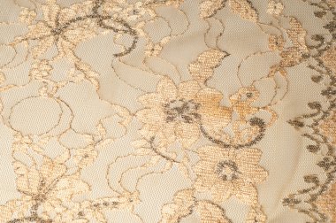 Doku. Kumaş altın sarı renkli fotoğraflar stüdyoda yapılan dantel. iyi bir açık kumaş, pamuk veya ipek, genellikle birini döngü, büküm veya desenleri iplik örgü tarafından yapılan ve özellikle hazır giyim süsleme için kullanılan.
