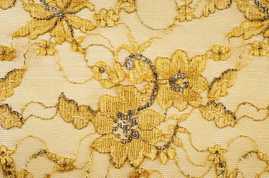 Doku. Kumaş altın sarı renkli fotoğraflar stüdyoda yapılan dantel. iyi bir açık kumaş, pamuk veya ipek, genellikle birini döngü, büküm veya desenleri iplik örgü tarafından yapılan ve özellikle hazır giyim süsleme için kullanılan.