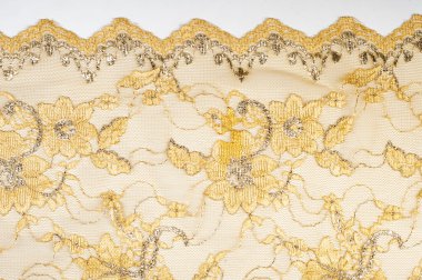 Doku. Stud oyununda yapılan dantel kumaş altın sarı renkli fotoğraflar