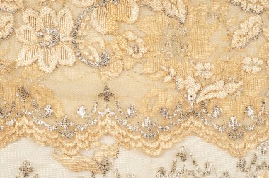 Doku. Kumaş altın sarı renkli fotoğraflar stüdyoda yapılan dantel. iyi bir açık kumaş, pamuk veya ipek, genellikle birini döngü, büküm veya desenleri iplik örgü tarafından yapılan ve özellikle hazır giyim süsleme için kullanılan.