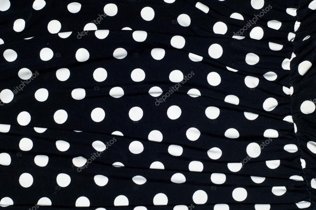 texture of silk fabric. background. white polka dots on a black