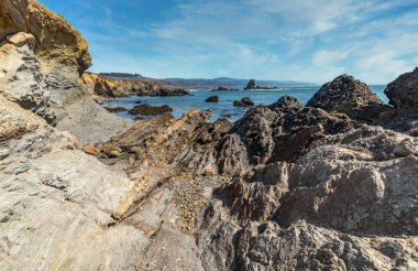 Kaliforniya 'nın Pasifik kıyılarının güzel deniz manzarası, dalgalar, kayalar, gökyüzü, güneş. Konsept, mükemmel kartpostal ve rehber.