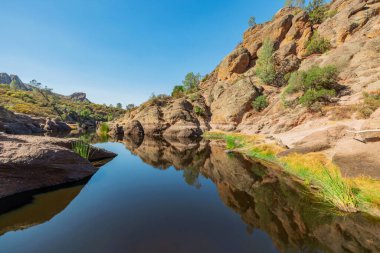 Lake Bear Gulch and rock formations in Pinnacles National Park in California, the ruined remains of an extinct volcano on the San Andreas Fault. Beautiful landscapes, cozy hiking trails for tourists clipart