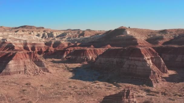 Vista aérea. Vuela sobre las rocas rojas de un cañón en el seco y soleado desierto de Utah en el oeste de Estados Unidos. — Vídeo de stock