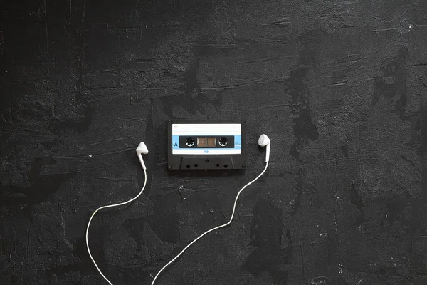Blue -White audio cassette and cassette pleer with headphones on a white background. Party 90s concept