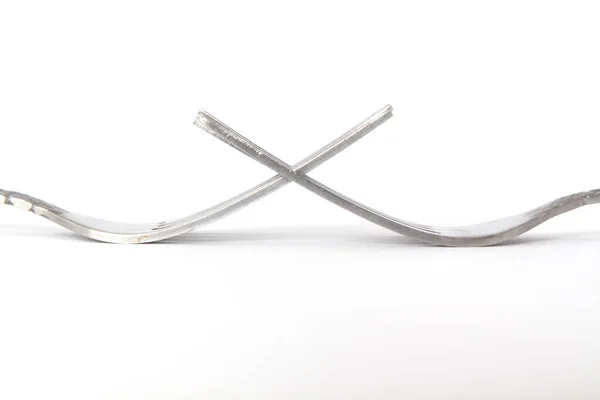 Closeup Crossed Tines Two Forks White Background Selective Focus — Stock Photo, Image