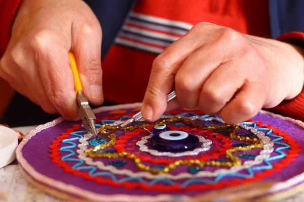 Man\'s hands making decoration ornament for the wall. Hobby photoshoot.