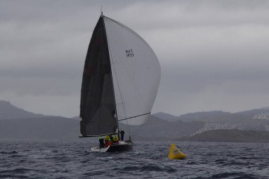 Bodrum, Türkiye. 20 Ocak 2018: Bodrum 'un ünlü tatil beldesi Bodrum' un kıyılarında, Ege Denizi 'nin mavi sularında rüzgarlı havada yelken açan yelkenliler.