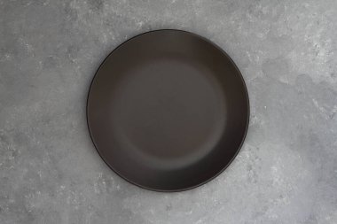 Karanlık taş masada boş siyah levha. Menü için yemek geçmişi, tarif. Masa ayarı. Flatlay, üst manzara. Restoran yemeği için maket.