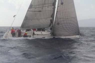 Bodrum, Türkiye. 11 Şubat 2018: Bodrum 'un ünlü tatil beldesi Bodrum' un kıyılarında, Ege Denizi 'nin mavi sularında rüzgarlı havada yelken açan yelkenliler.
