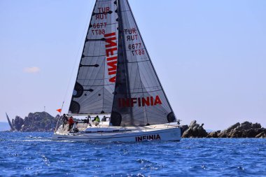 Bodrum, Hindi. 16 Mart 2024: Yelkenliler Ege Denizi 'nin mavi sularında, ünlü tatil beldesi Bodrum' un kıyılarında rüzgarlı havada yelken açıyorlar..