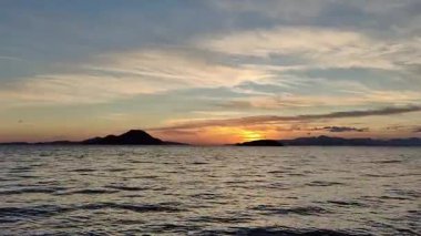 Sonbaharda Ege Denizi üzerinde bulutlu bir günde muhteşem bir gün batımı..