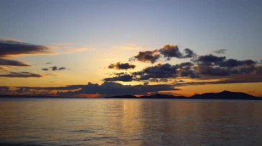 Sonbaharda Ege Denizi üzerinde bulutlu bir günde muhteşem bir gün batımı..