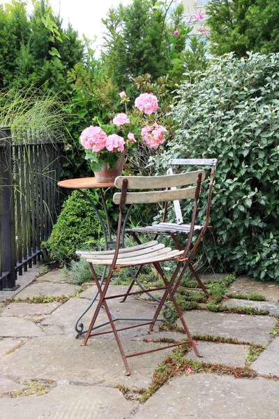 Garden furniture and geraniums — Stock Photo, Image