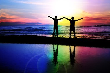 Gay couple at sunset clipart