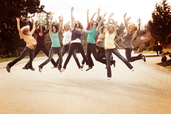 Girl friends jumping for joy