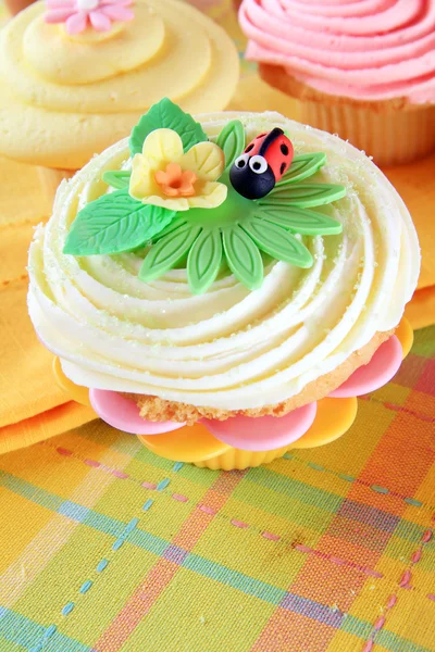 Cupcake with flower and ladybug — Stock Photo, Image