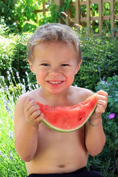 Boy eating slice of watermelon — Stock Photo, Image