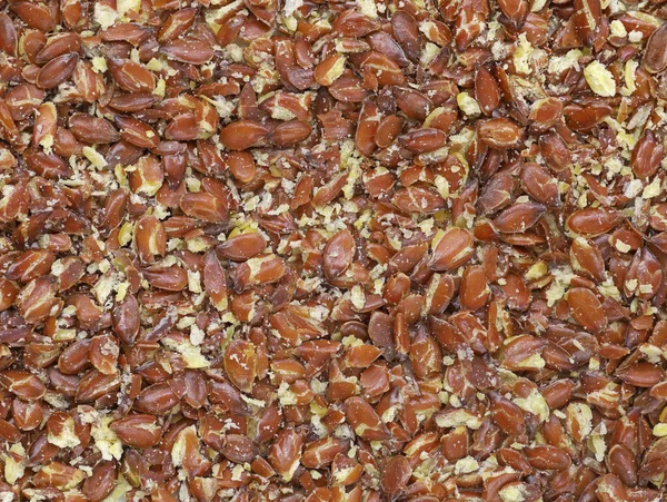 Crushed flaxseed as background, linseed texture top view — Stok fotoğraf