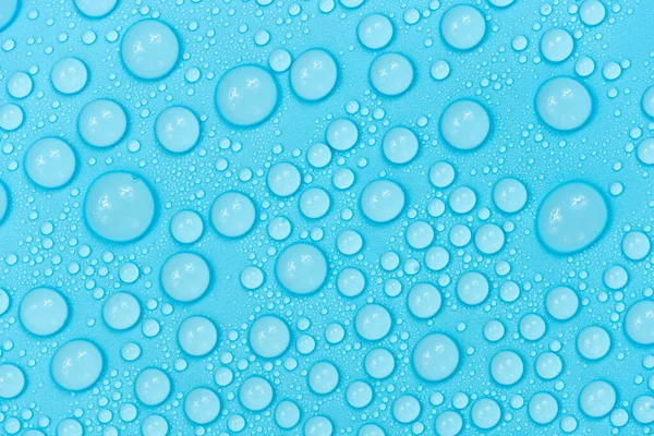 Mavi arkaplan dokusuna su damlaları. Arkaplan camı su damlalarıyla kaplı. Sudaki kabarcıklar