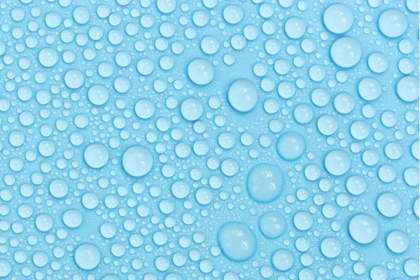 Water drops on blue background texture. Backdrop glass covered with drops of water. bubbles in water