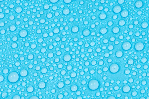 Water drops on blue background texture. Backdrop glass covered with drops of water. bubbles in water