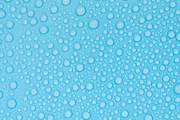 Water drops on blue background texture. Backdrop glass covered with drops of water. bubbles in water