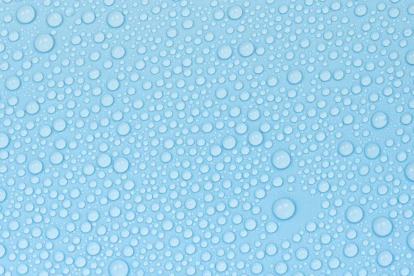 Water drops on blue background texture. Backdrop glass covered with drops of water. bubbles in water