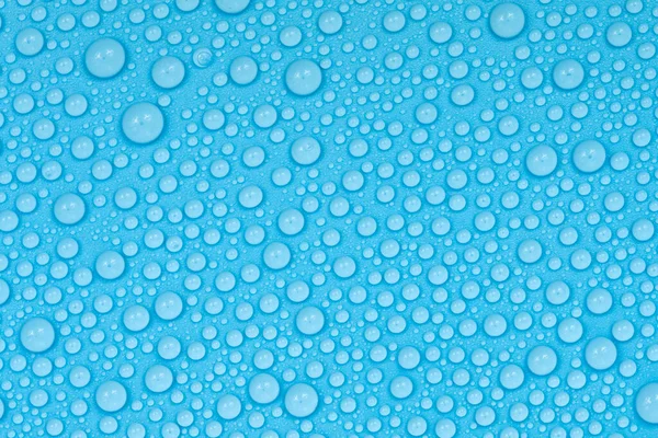 Water drops on blue background texture. Backdrop glass covered with drops of water. bubbles in water