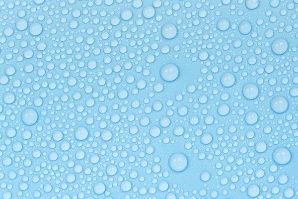 Water drops on blue background texture. Backdrop glass covered with drops of water. bubbles in water
