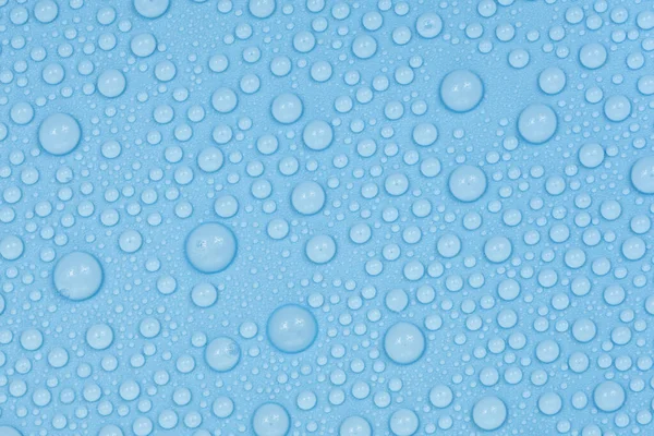 Water drops on blue background texture. Backdrop glass covered with drops of water. bubbles in water