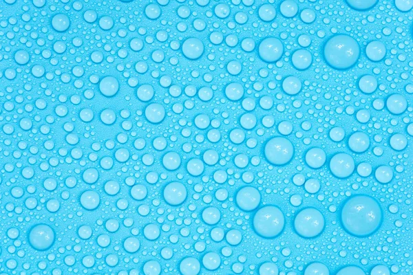 Water drops on blue background texture. Backdrop glass covered with drops of water. bubbles in water